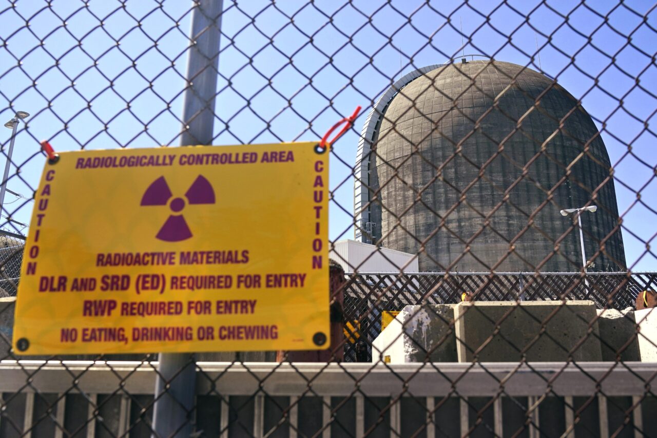A sign warning of radioactive materials is seen on a fence outside Indian Point Energy Center in Buchanan, N.Y. just days before it close in 2021. The Trump administration is seeking to overhaul nuclear safety rules to aid a nuclear revival.