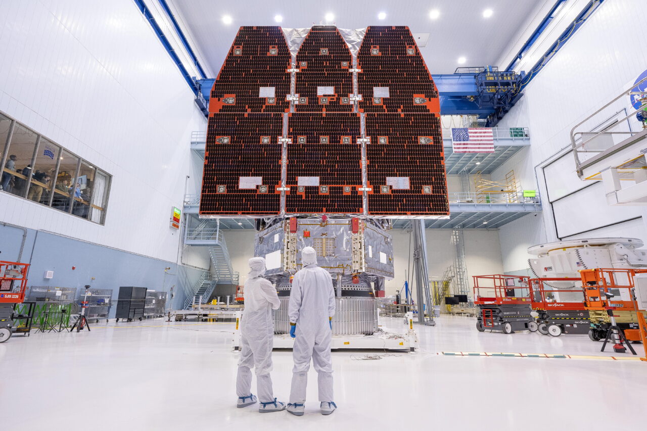 In a large cavernous room, technicians wearing white head-to-toe suits connect the inner and outer segments of NASA's Nancy Grace Roman Space Telescope in 2025 at NASA’s Goddard Space Flight Center in Greenbelt, Maryland.