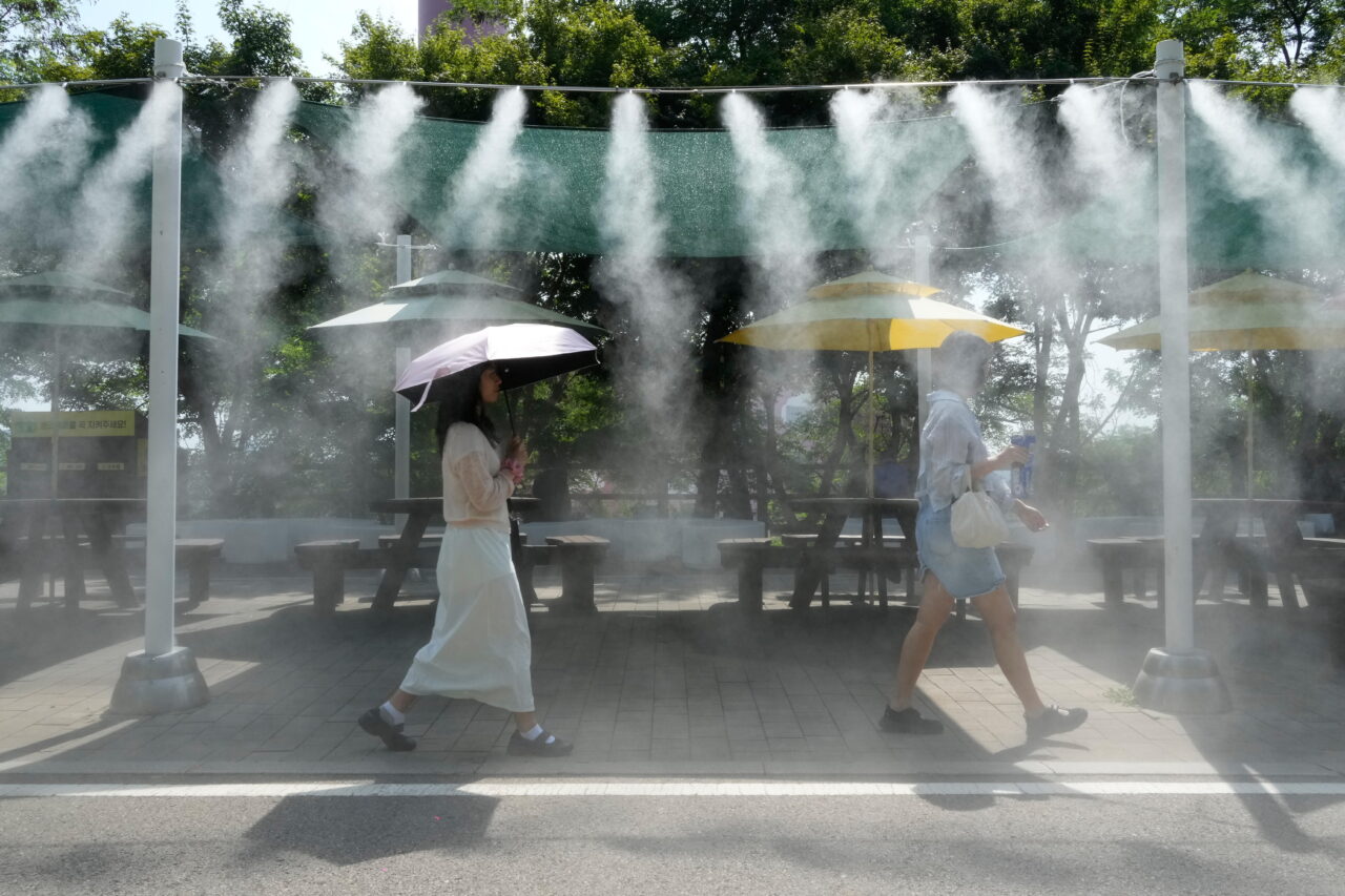 Visitors pass by the cooling fog device at Gwangmyeong Cave tourist site in Gwangmyeong, South Korea, Aug. 6, 2026.