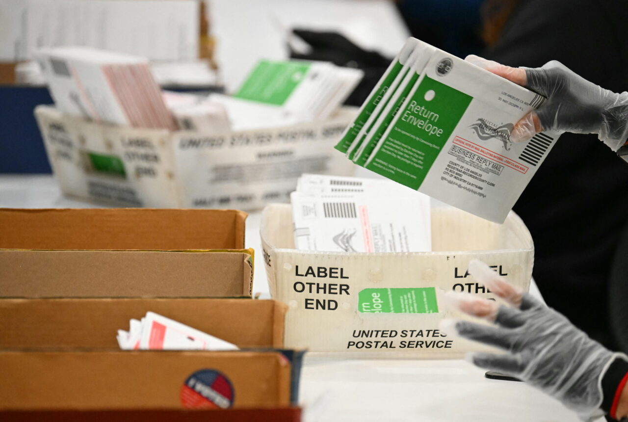 Election workers process mail-in ballots in Industry, Calif., in June.
