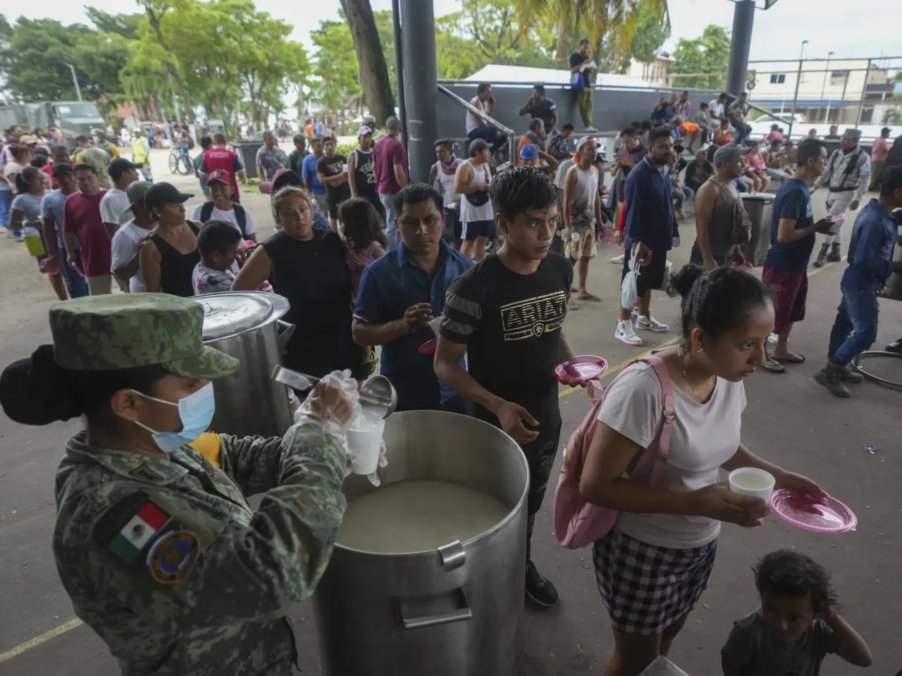 People line up to receive food at an army-provided soup kitchen for those affected by Hurricane Beryl in Tulum, Mexico, Friday, July 5, 2024.