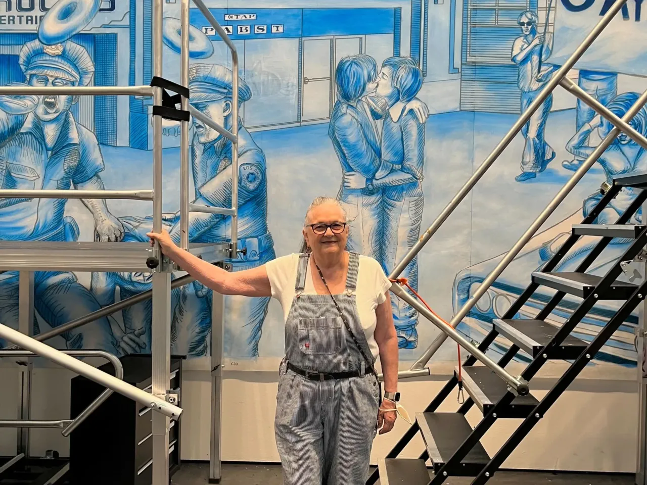 The half-mile long Great Wall of Los Angeles mural is getting longer 1 Judy Baca stands in front of the mural that depicts images symbolizing the gay rights movement in Los Angeles.