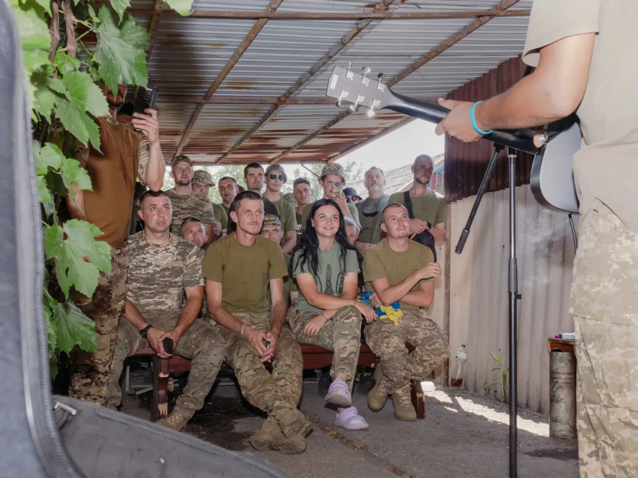 How these Ukrainian artists are using their talents to support the war effort 20 Ukrainian soldiers watch a music performance in a driveway of the home where currently being used as a base, on the front in eastern Ukraine.