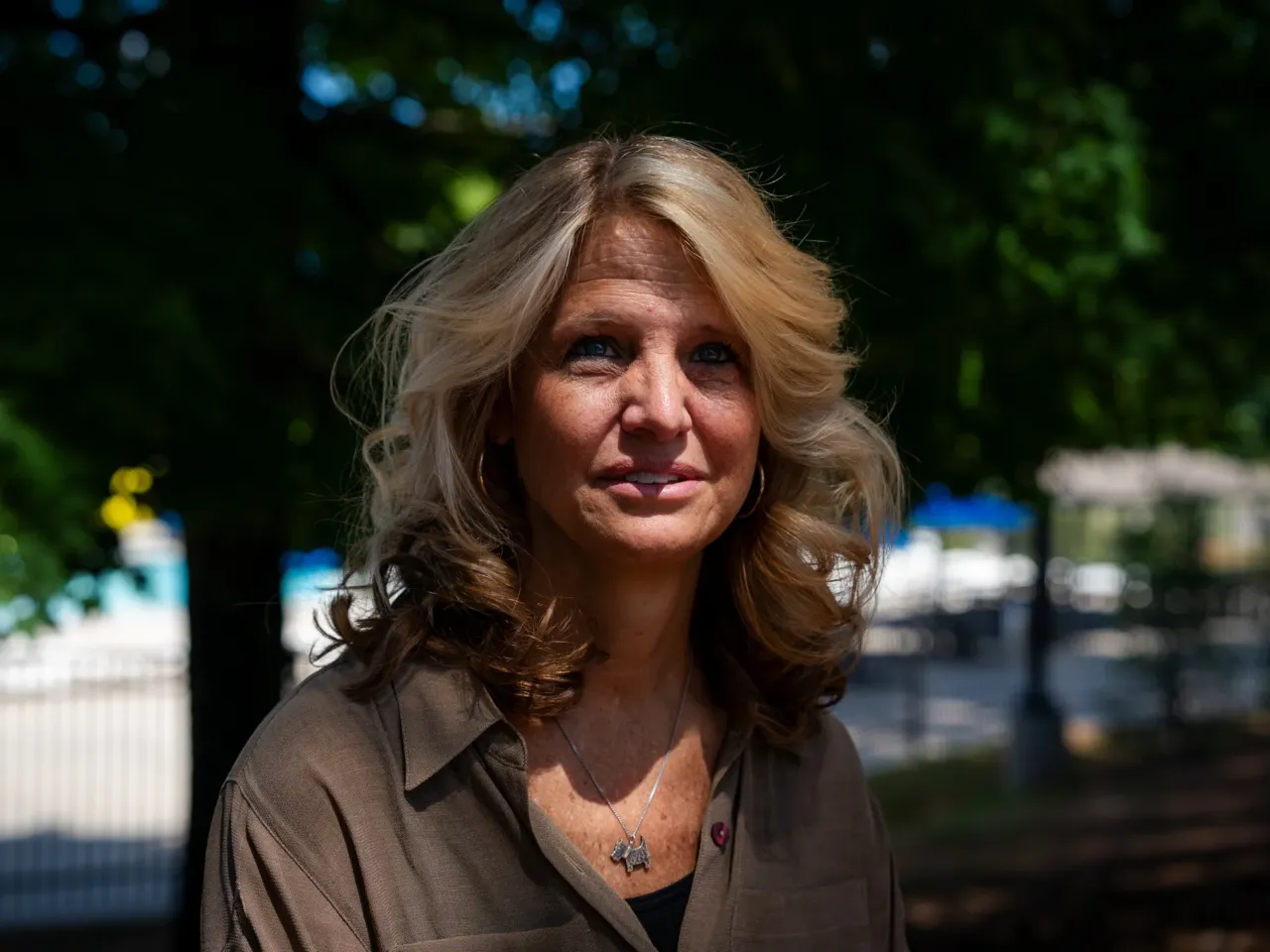 Kerry Webster, a voter who says she voted for Trump in 2020 but isn't sure she will again in 2024, poses for a photo at the Wills Park Pool in Alpharetta, Ga.