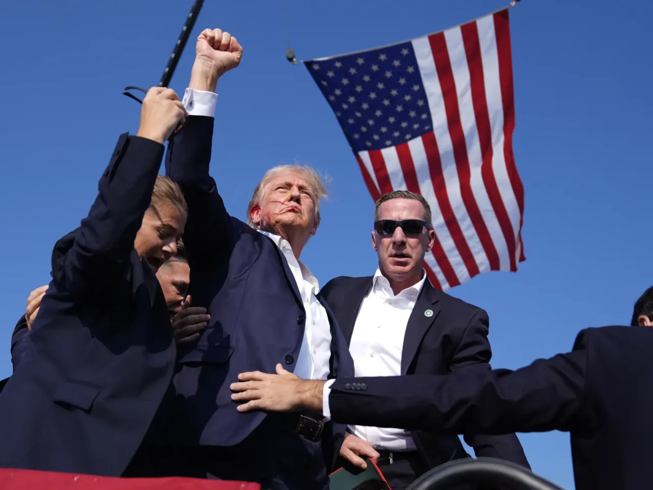 Former President Donald Trump is rushed offstage during a rally in Butler, Pa.