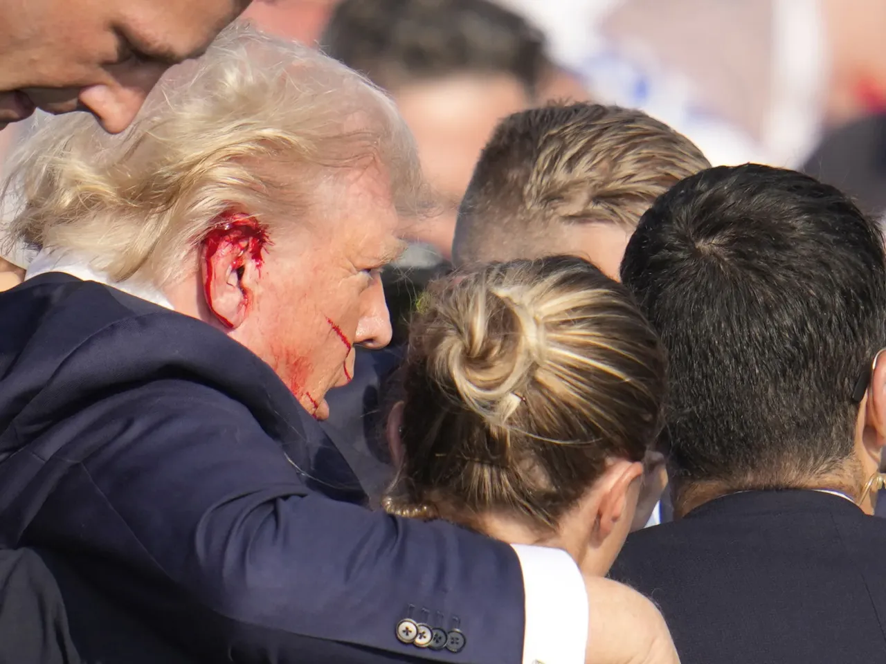 Photos: See how the Trump rally shooting unfolded 1 Republican presidential candidate former President Trump is surrounded by U.S. Secret Service agents as he is helped off the stage at a campaign rally in Butler, Pa.