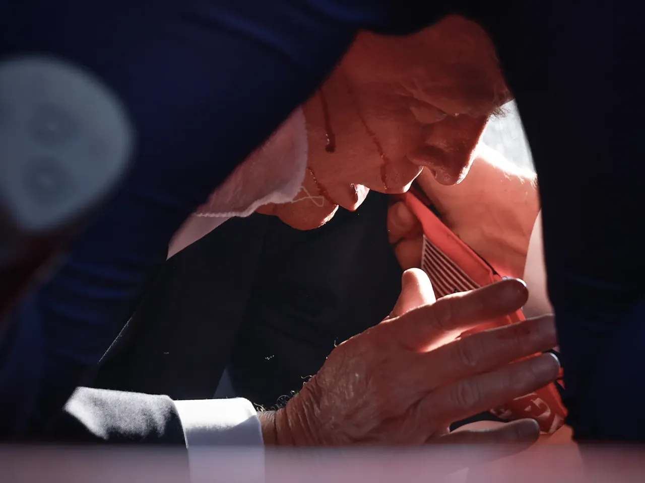 Photos: See how the Trump rally shooting unfolded 4 Republican presidential candidate former President Trump is shown covered by U.S. Secret Service agents after an incident.