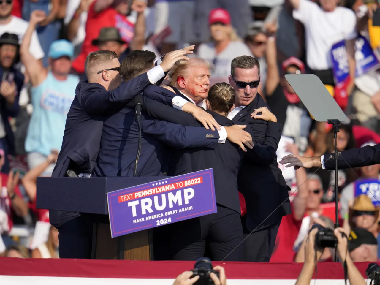 Photos: See how the Trump rally shooting unfolded 6 Republican presidential candidate former President Trump is helped off the stage.