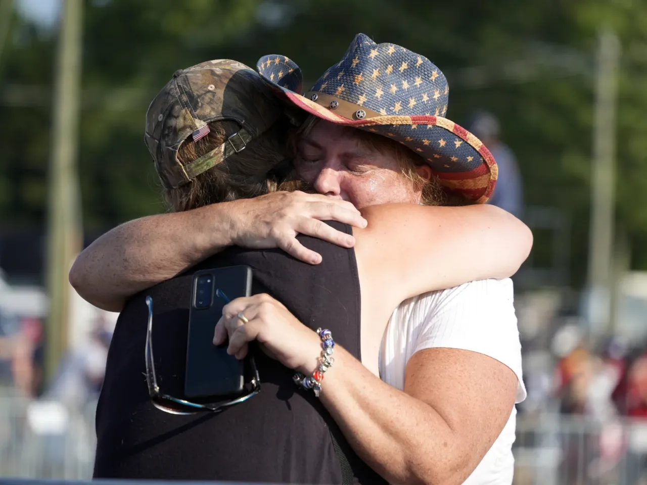 Photos: See how the Trump rally shooting unfolded 10 People hug after Republican presidential candidate former President Trump was helped off the stage.