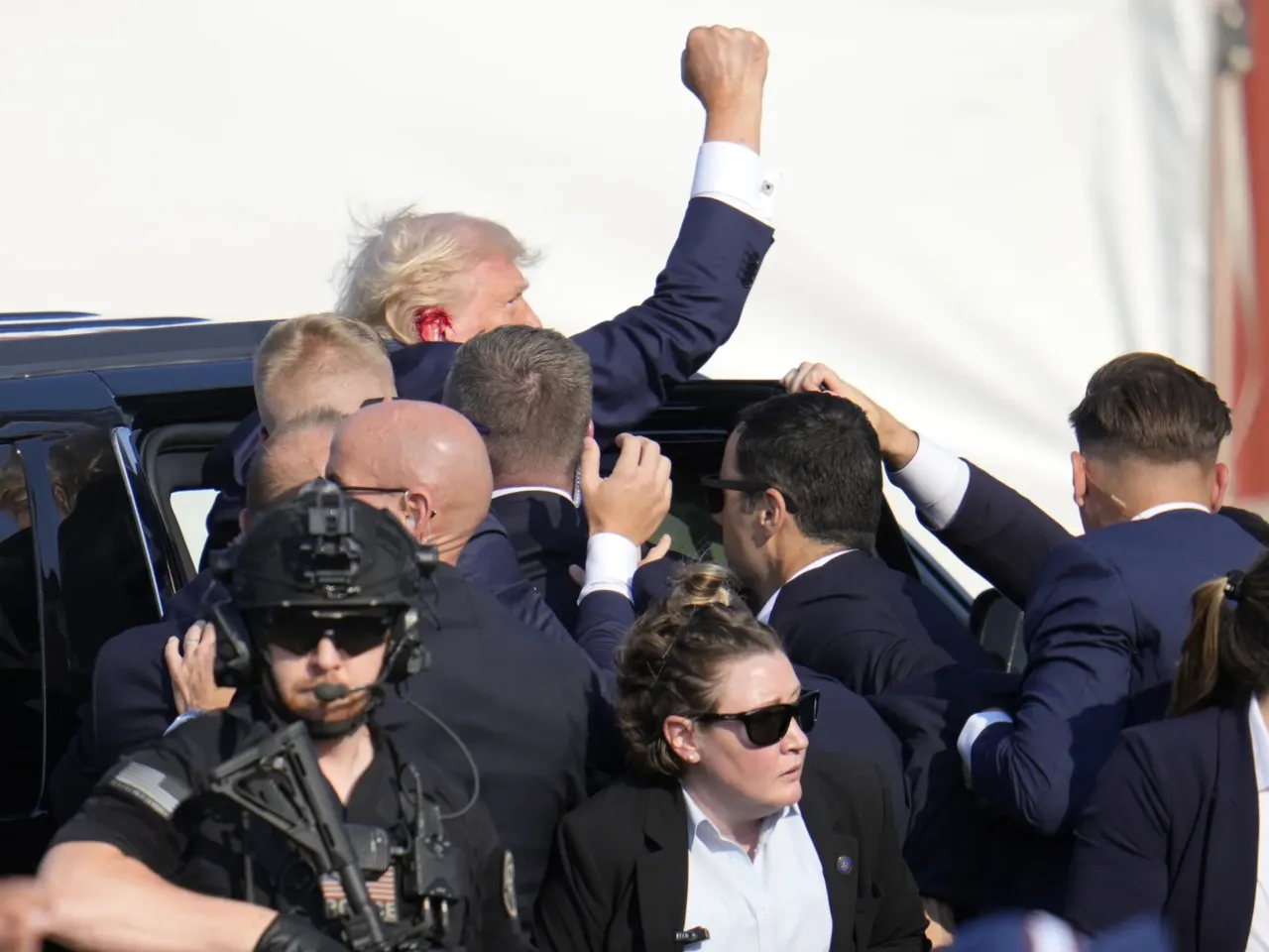 Photos: See how the Trump rally shooting unfolded 13 Republican presidential candidate former President Trump is helped off the stage.