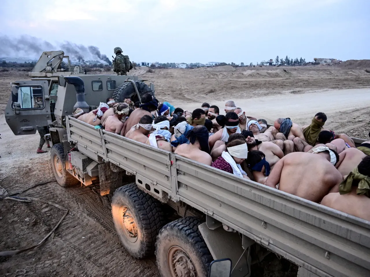 Palestinian detainees from Gaza say they are facing abuse in Israeli prisons 1 Israeli soldiers stand by a truck with Palestinian detainees in the Gaza Strip, Dec. 8, 2023.