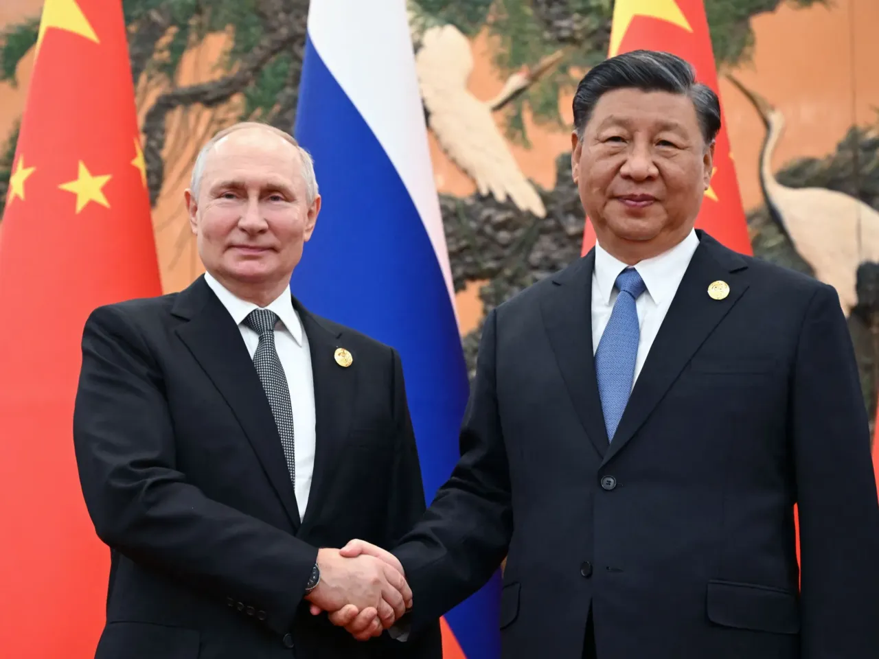 U.S. Ambassador exits China, saying the global rival 'underestimated the U.S.' 3 Russian President Vladimir Putin and Chinese President Xi Jinping shake hands during a meeting in Beijing on Oct. 18, 2023.
