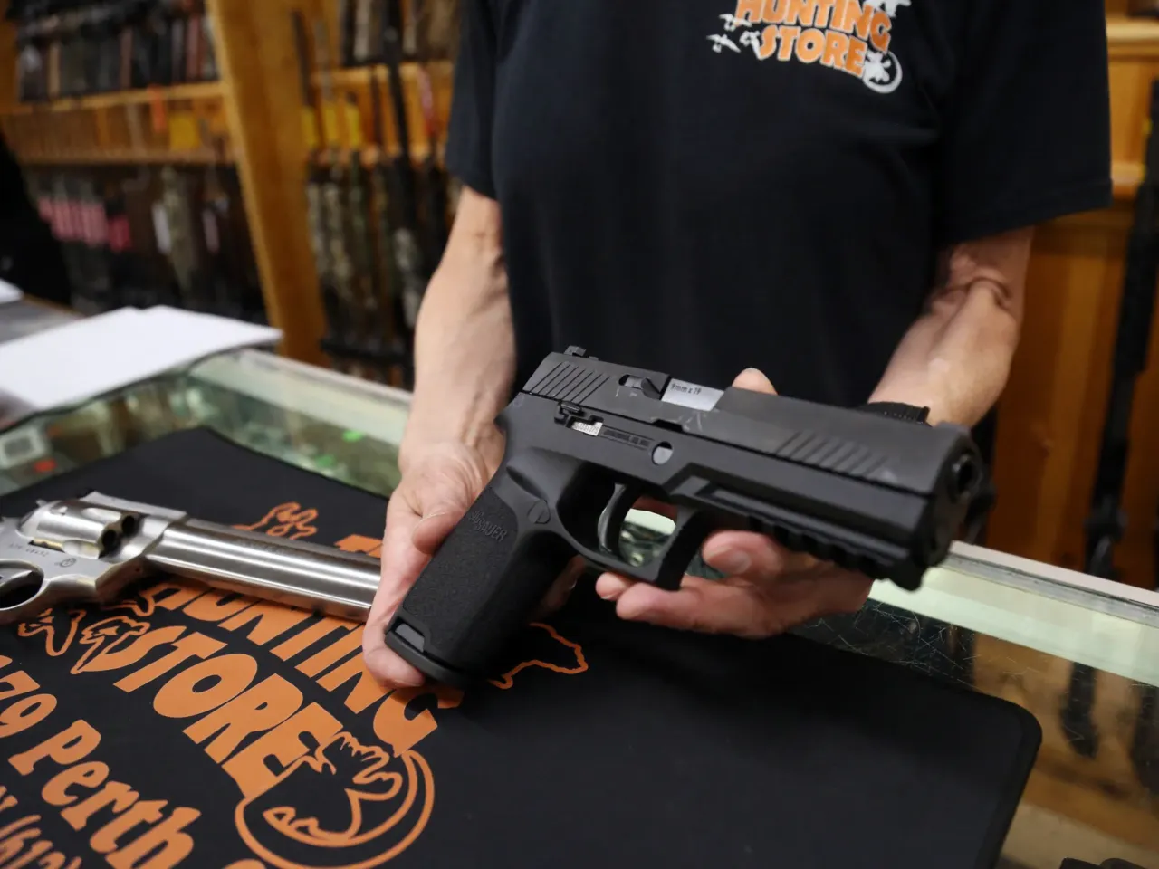 A Sig Sauer P320 9mm handgun from the display case at That Hunting Store in Ottawa, Canada.