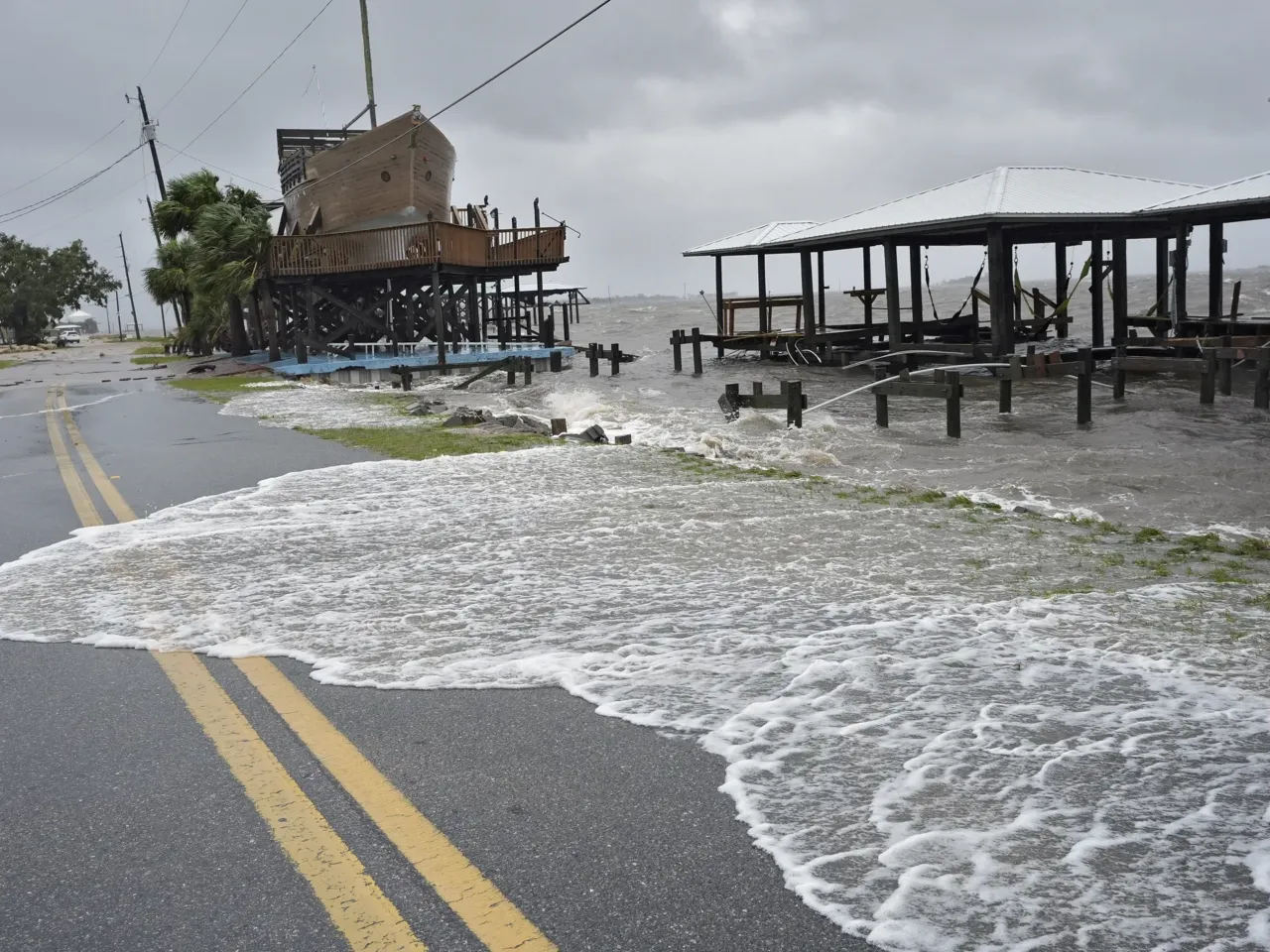 Storm surge breaks over a small sea wall near boat docks in Horseshoe Beach, Florida, on Monday, August 5.