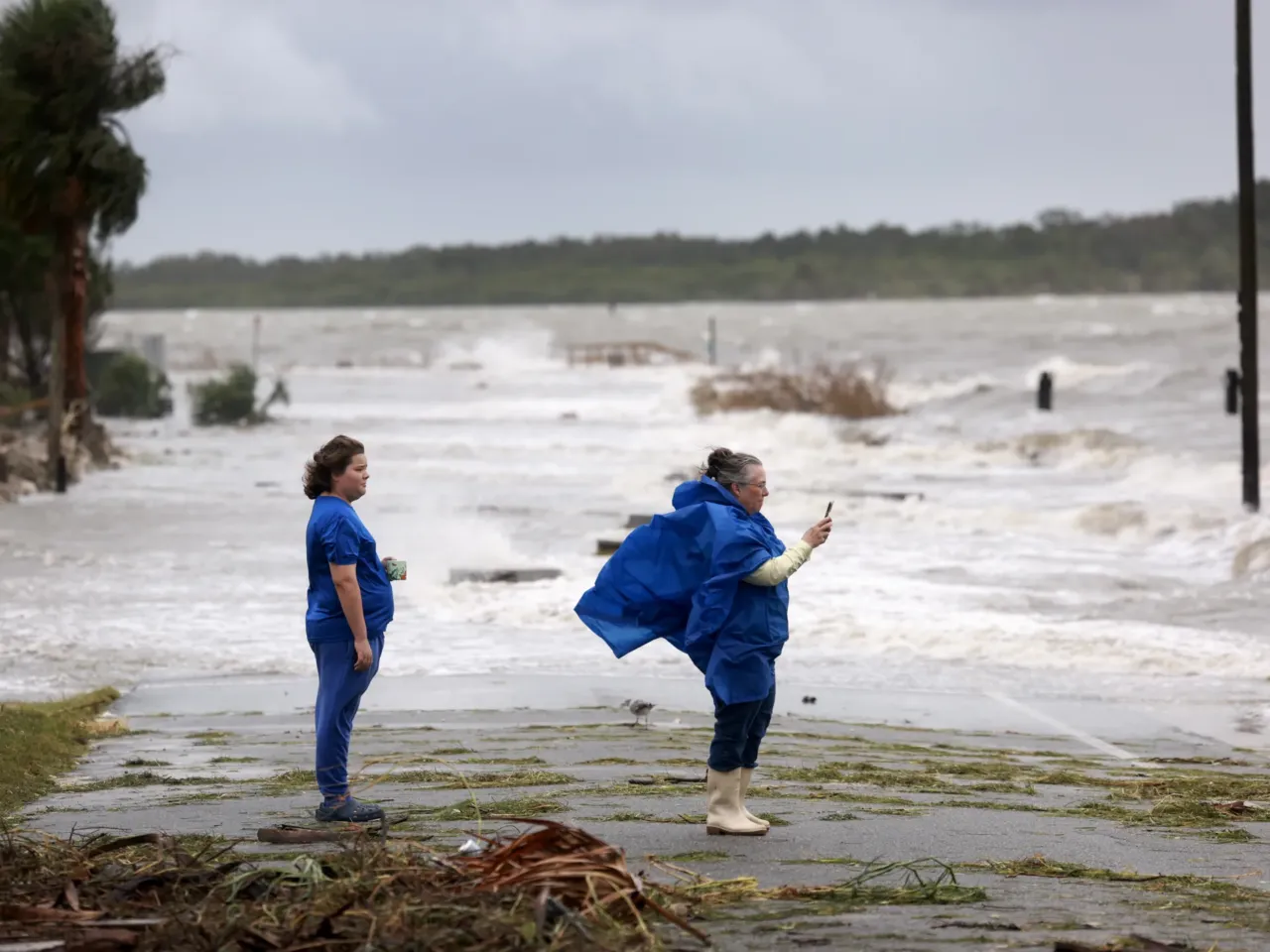 Jaiden Skinner, left, and Nani Hicks check on their neighborhood as high winds, rain and storm surge from Hurricane Debby inundate Cedar Key, Florida, on Monday, August 5.