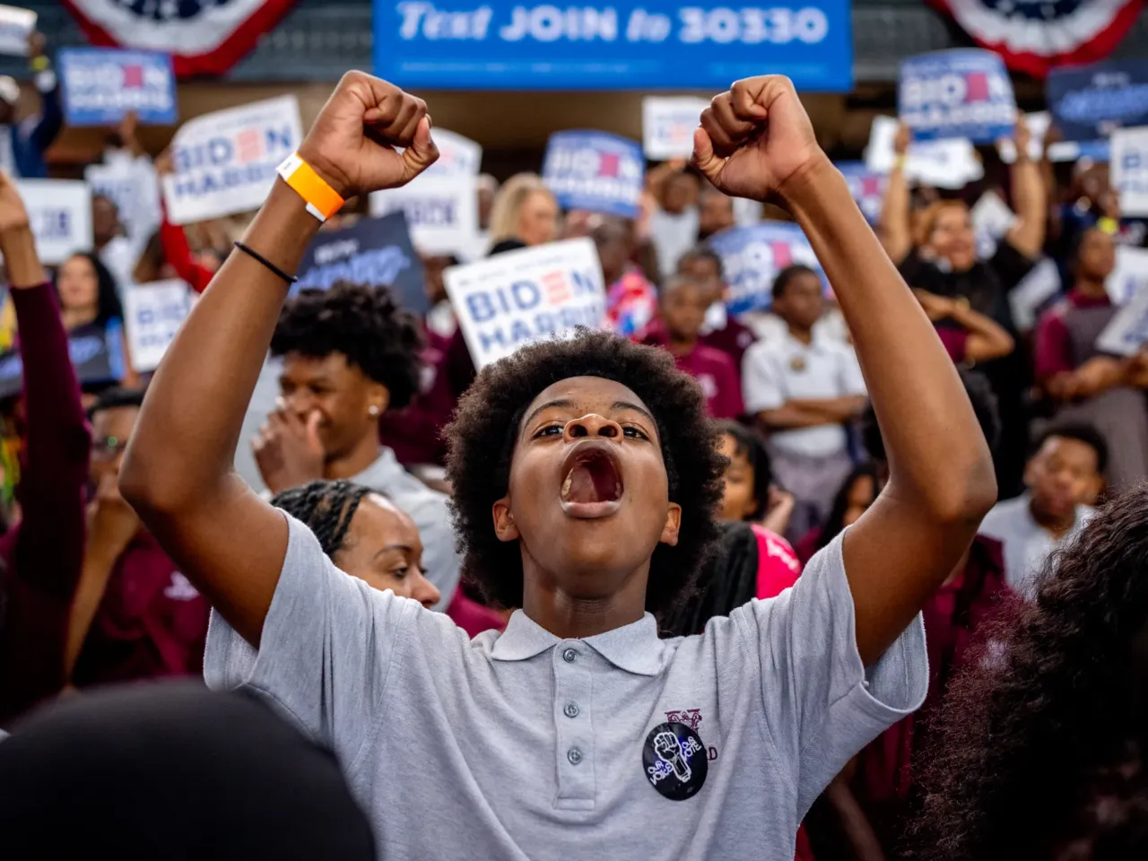 Young Black voters are becoming more conservative than their parents. Here's why 1 A member of the audience cheers as President Biden speaks during a campaign rally at Girard College on May 29 in Philadelphia. Biden has since dropped out of the race in favor of Vice President Harris and this event launched a nationwide campaign to court Black voters, a group that has traditionally come out in favor of Biden, but their support projected lower for him than it was in 2020. Harris' stake with the group is yet to be seen.