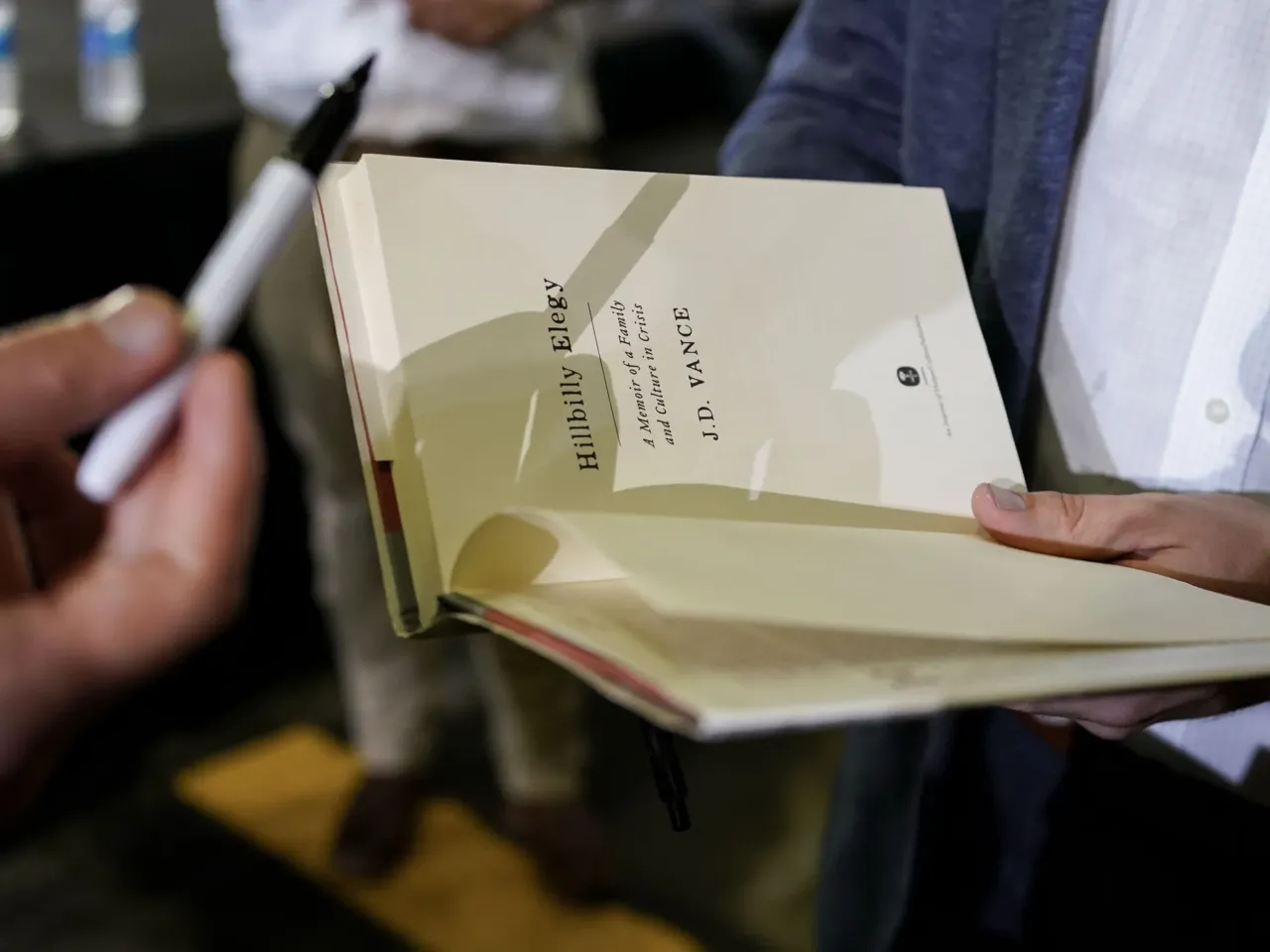 'Hillbilly Elegy' is back in the spotlight. These Appalachians write a different tale 2 JD Vance autographs a book after a rally on July 1, 2021, in Middletown, Ohio.