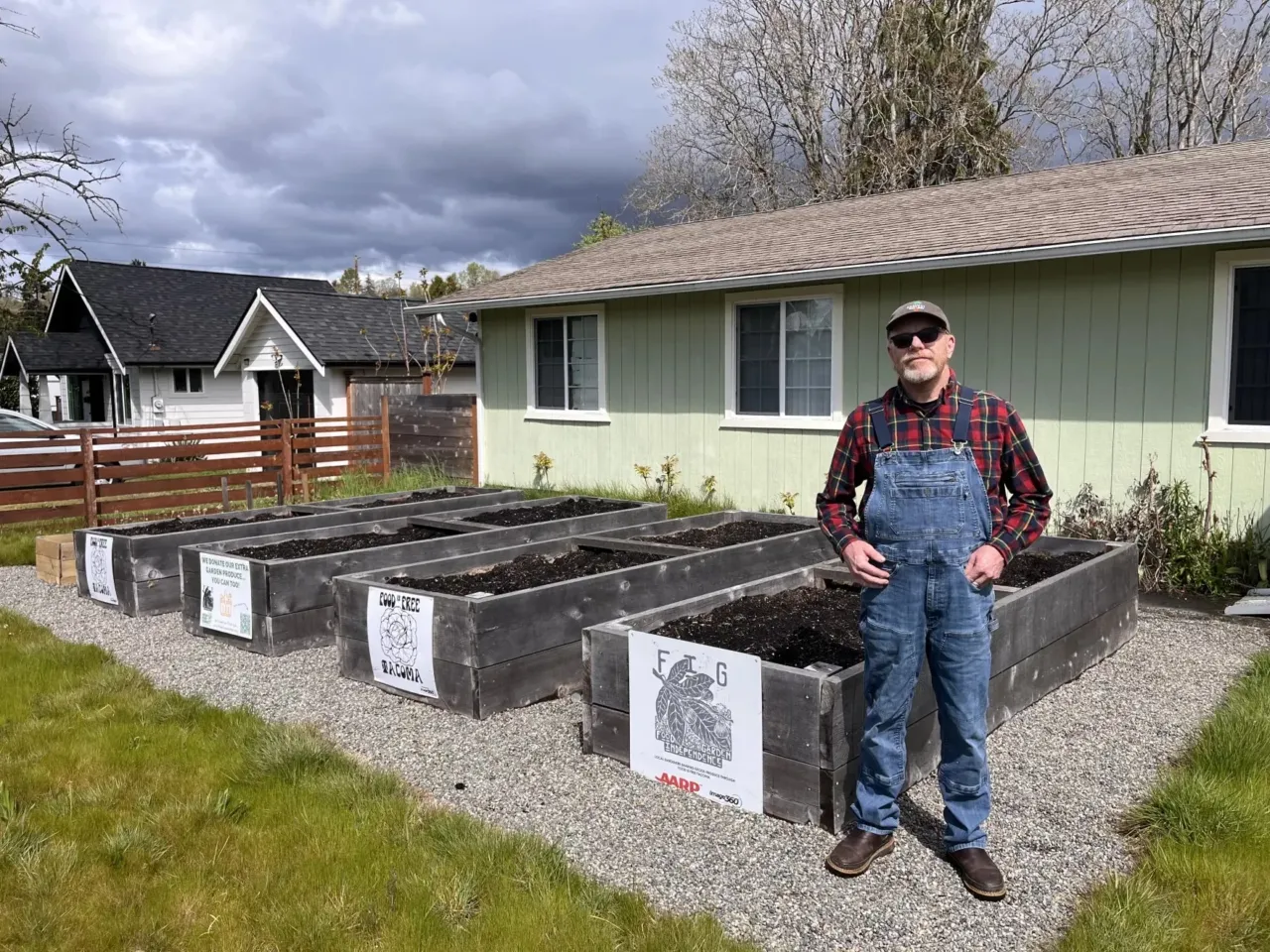 Creative ways communities are reducing food waste 4 David Thompson stands in front of six raised garden beds at Triple Earl Farms, a Food Independence Garden in a South Tacoma neighborhood maintained by Thompson's organization Food is Free Washington on April 26, 2024.