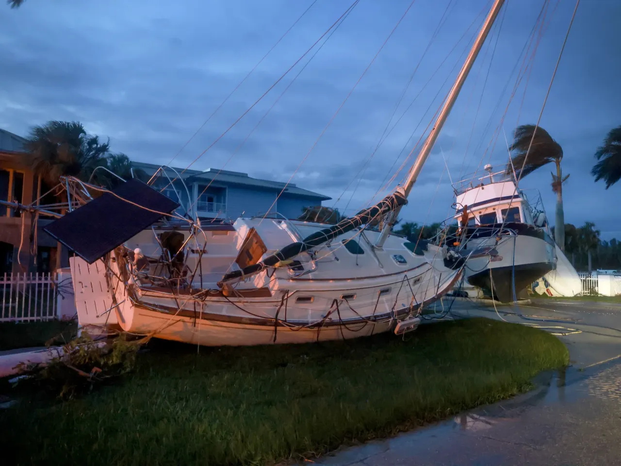 Boats rest in a yard after they were washed ashore when Hurricane Milton passed through the area in Punta Gorda, Florida. The storm made landfall as a Category 3 hurricane in the Siesta Key area of Florida, causing damage and flooding throughout Central Florida.