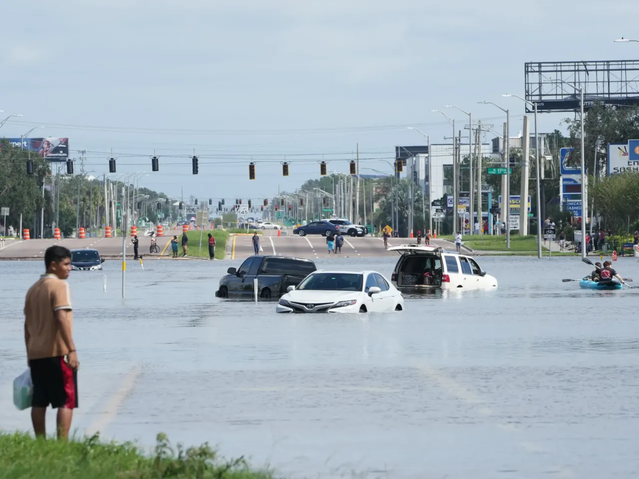 A young man looks on as cars are flooded in the water as the streets of the Southeast Seminole Heights section of Tampa due to Hurricane Milton on October 10, 2024 in Fla.