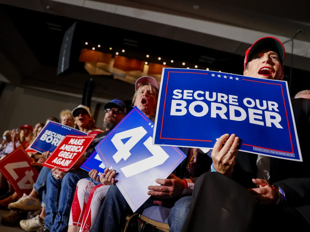 Trump rallies in Aurora -- a city he has demonized as overrun by migrant crime 1 People cheer ahead of Trump's rally in Aurora, Colo.