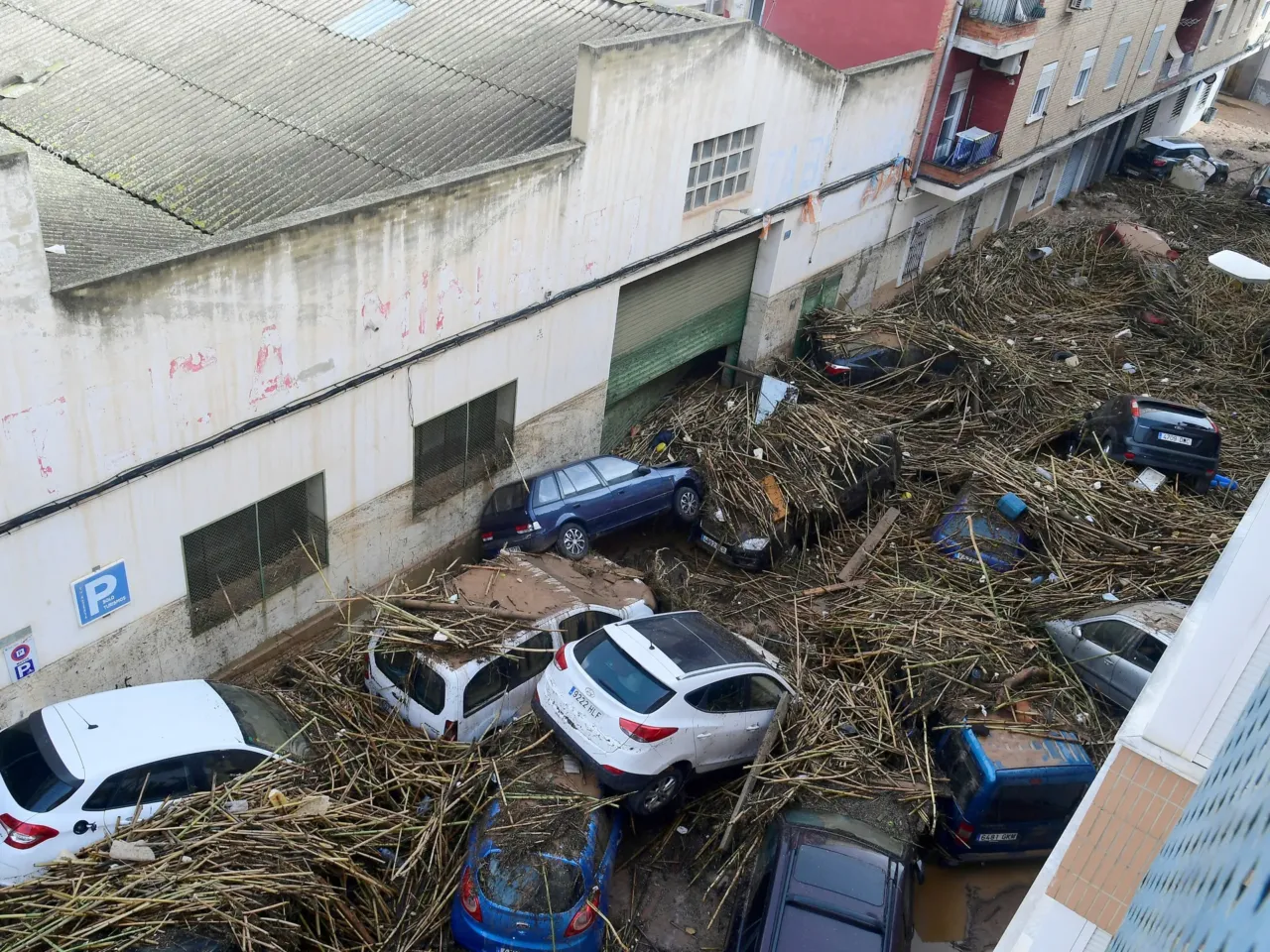 A picture taken in Picanya, near Valencia, eastern Spain, shows cars piled in a street after floods.