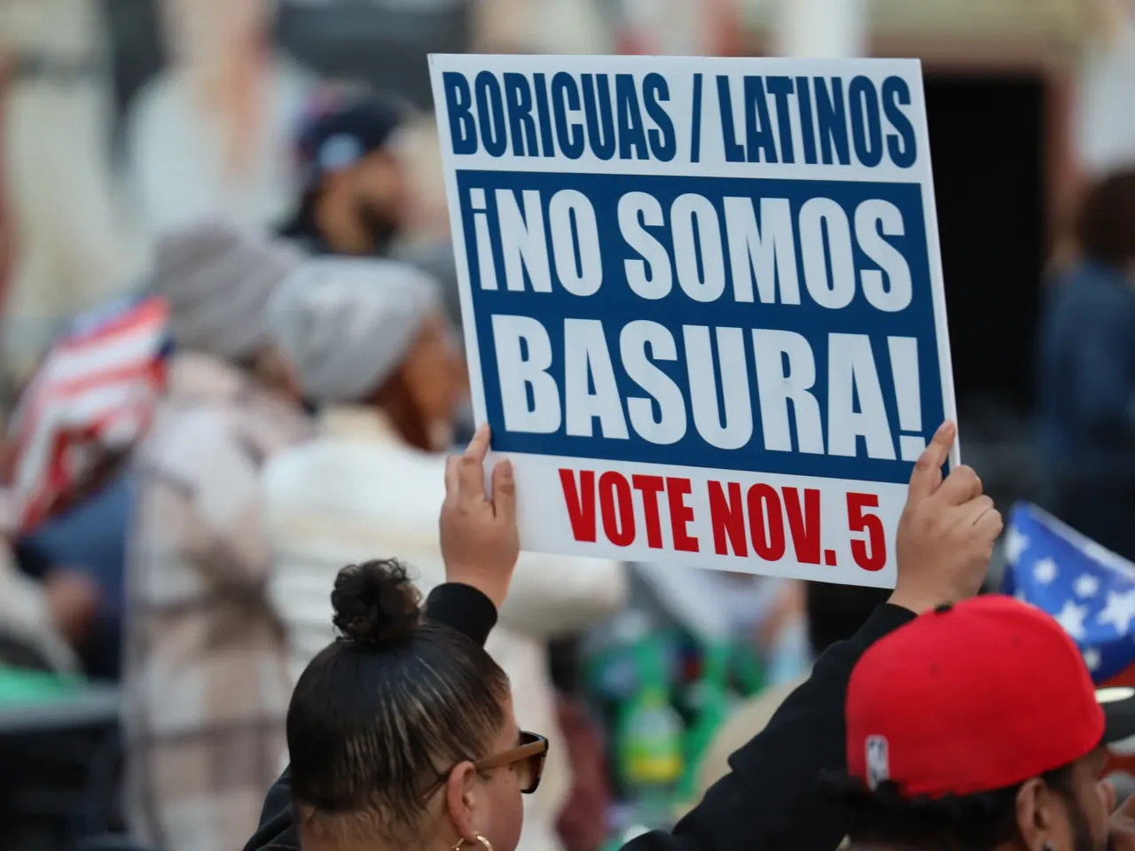 Trump and Harris were in Reading, Pa., today, thanks to a comment about Puerto Rico 2 A woman holds a sign at a rally organized by the Democratic Party in Reading, Pa., on Saturday.