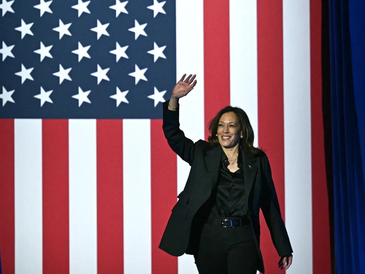Harris waves as she arrives to speak at a rally at the Wisconsin State Fair Park in Milwaukee on Friday.