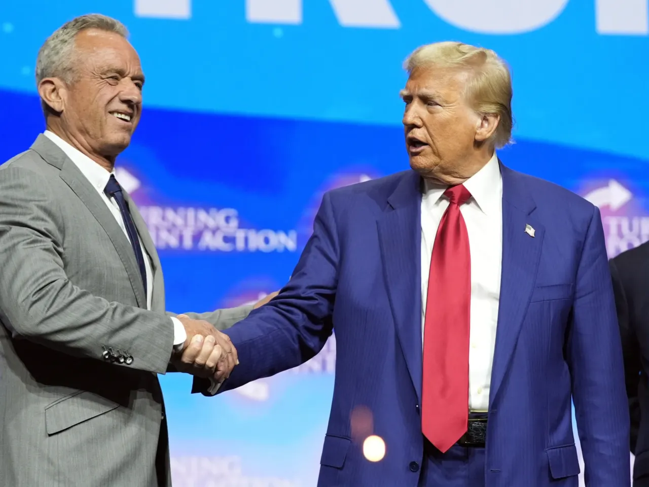 President-elect Donald Trump shakes hands with Robert F. Kennedy Jr., at a campaign rally in October. Kennedy, who is skeptical of vaccines, is among Trump's advisors on health.