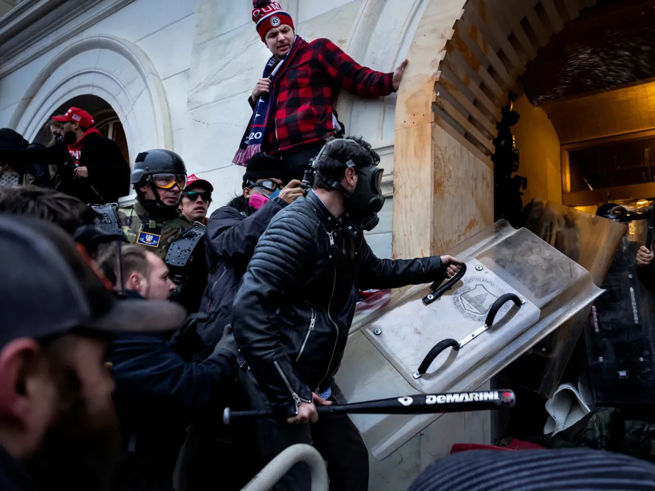 Jake Lang, center, and other Trump supporters clash with police during the Jan. 6, 2021 attack on the U.S. Capitol. Lang has gotten into new legal trouble since Trump issued mass pardons to the Jan. 6 defendants.