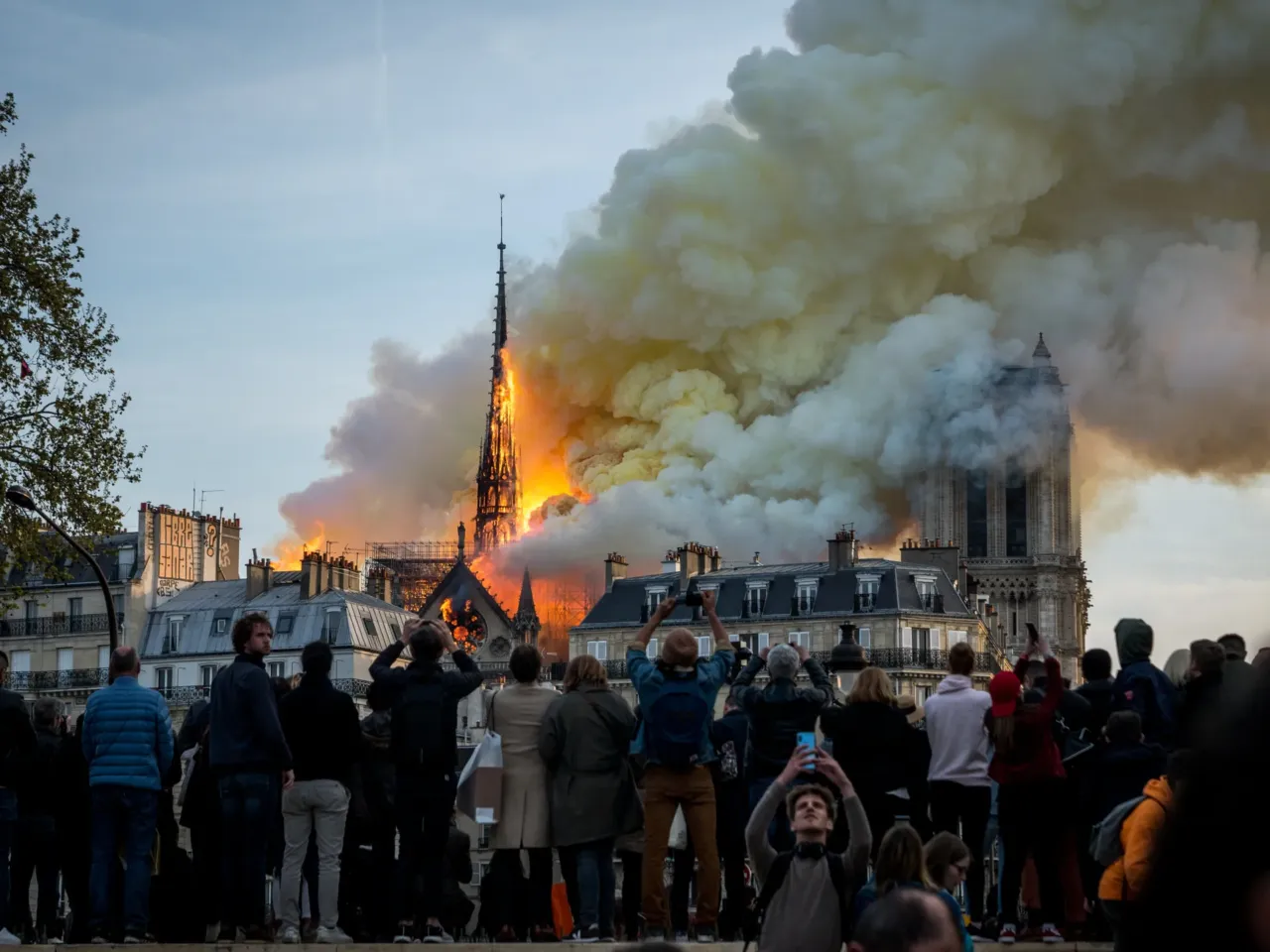 People watch the landmark Notre Dame Cathedral burning in central Paris on April 15, 2019.