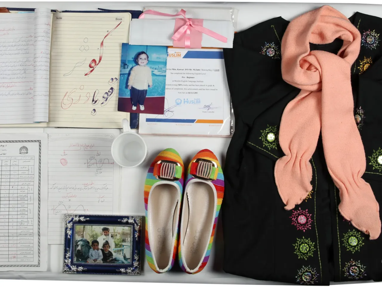 The Afghanistan Memory Home Museum creates "memory boxes" with personal belongings and photographs and documents for those who suffered or died in the country's conflicts. This memory box memorializes Kawsar Qubadian and includes her sweater and slippers.