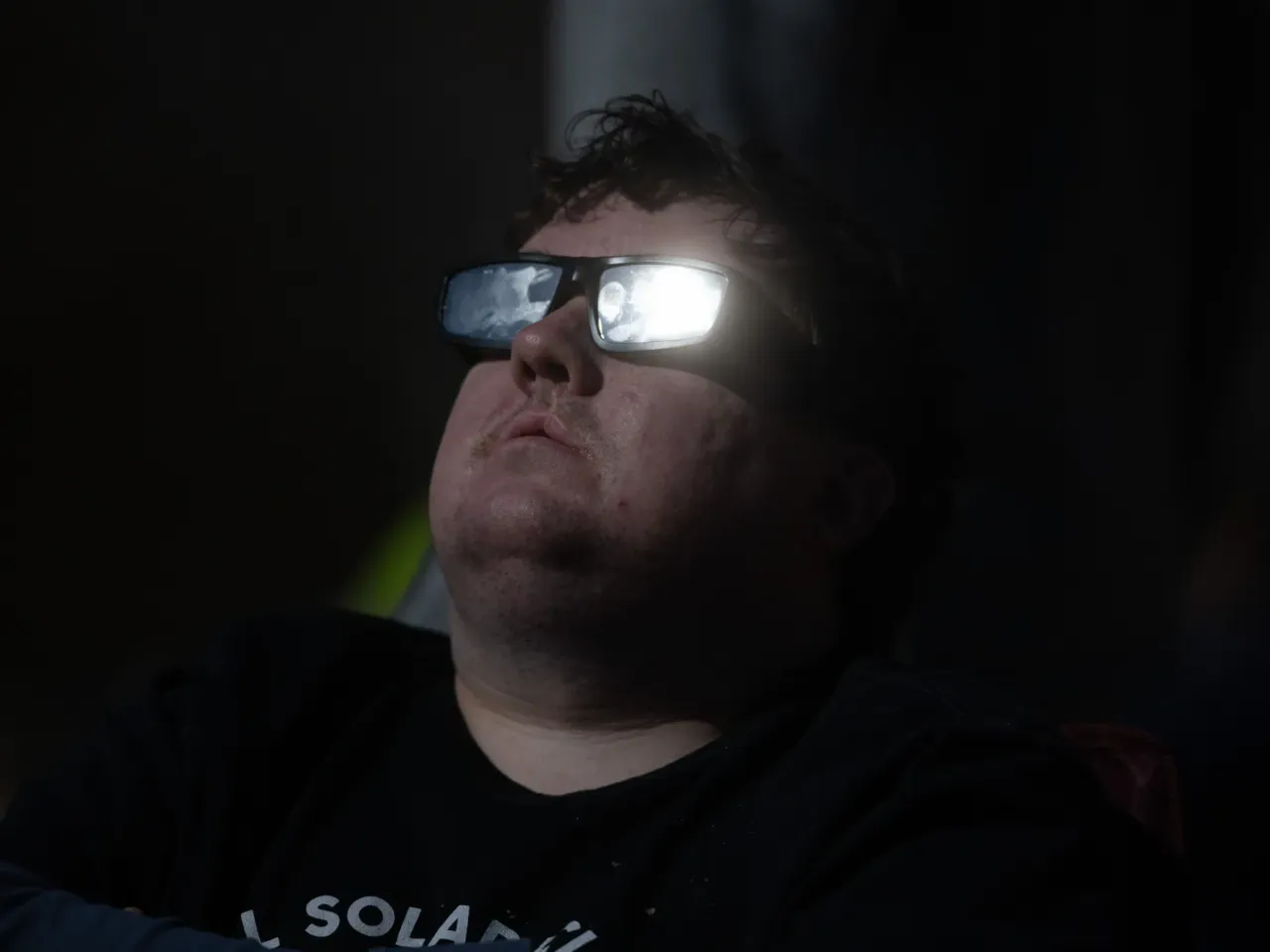 In a year of tough news, these are some of the stories that made us smile in 2024 2 The sun catches the solar glasses of a man watching the Great North American Eclipse on April 8 in Colebrook, N.H.