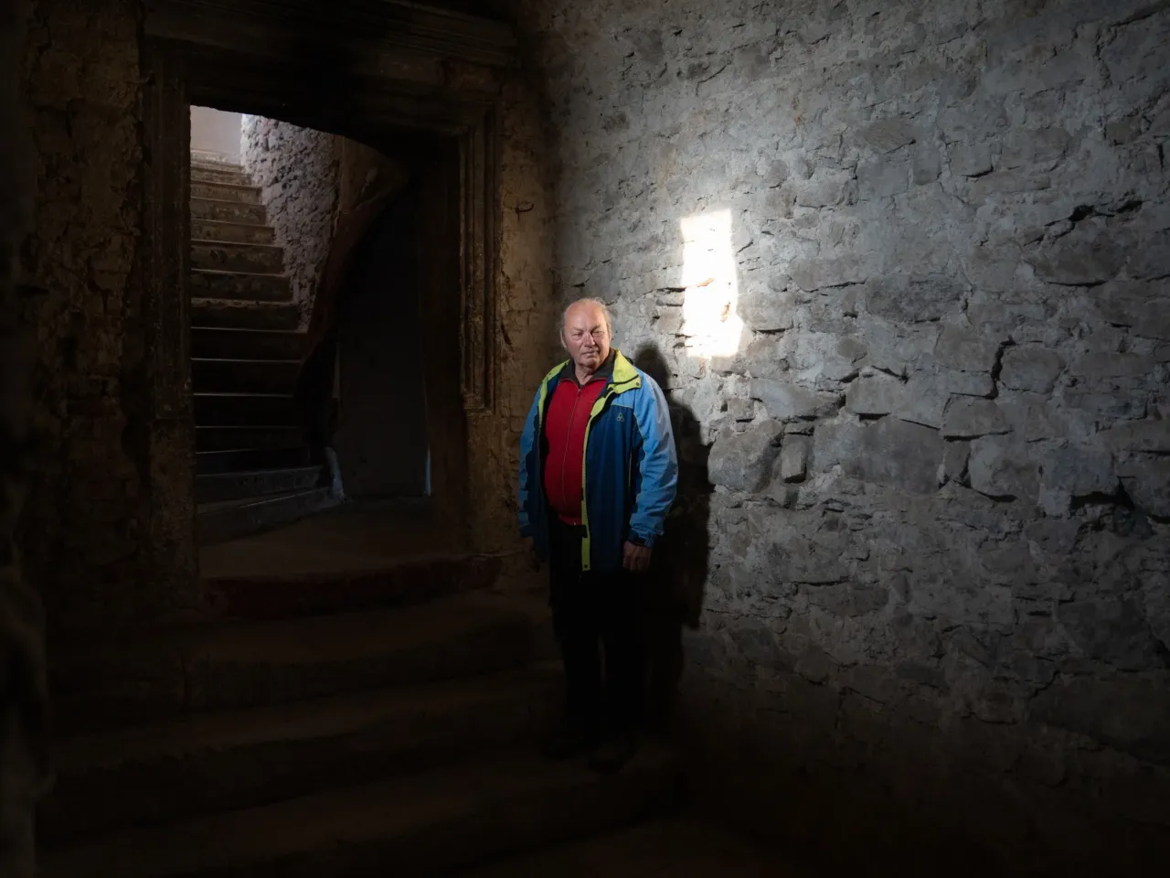 Joseph Bartosh stands in a patch of window light at St. Miklos Castle in Chynadiiovo, a town in western Ukraine. Since 2000, he's taken on the effort of restoring the medieval castle, whose earliest known mention is believed to be around 1450.