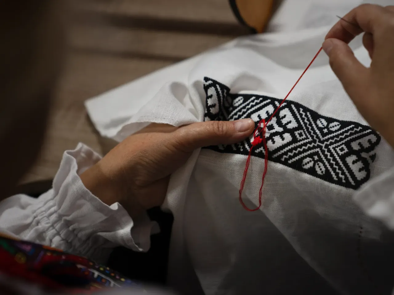 Hanna Haiduk uses a needle and thread to form intricate designs, many of which she copies from historical works she finds in books or those she saved from her family's past work.
