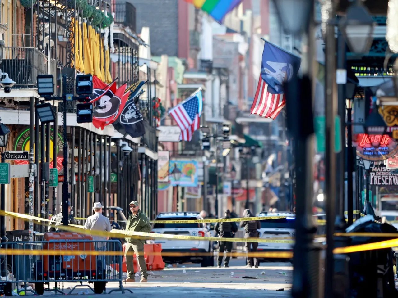 Law enforcement officers from multiple agencies work the scene on Bourbon Street.