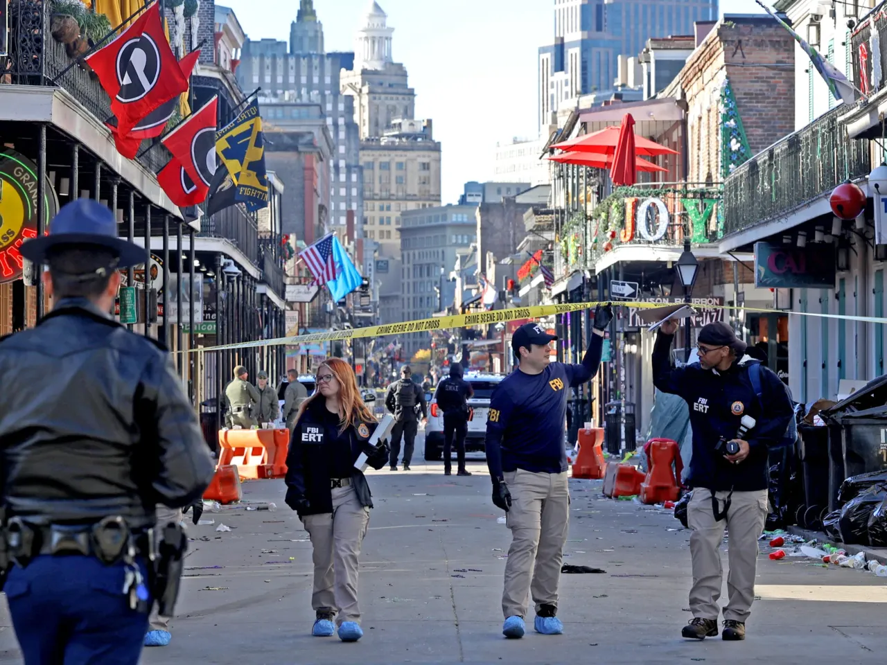 Law enforcement officers from multiple agencies work the scene on Bourbon Street.