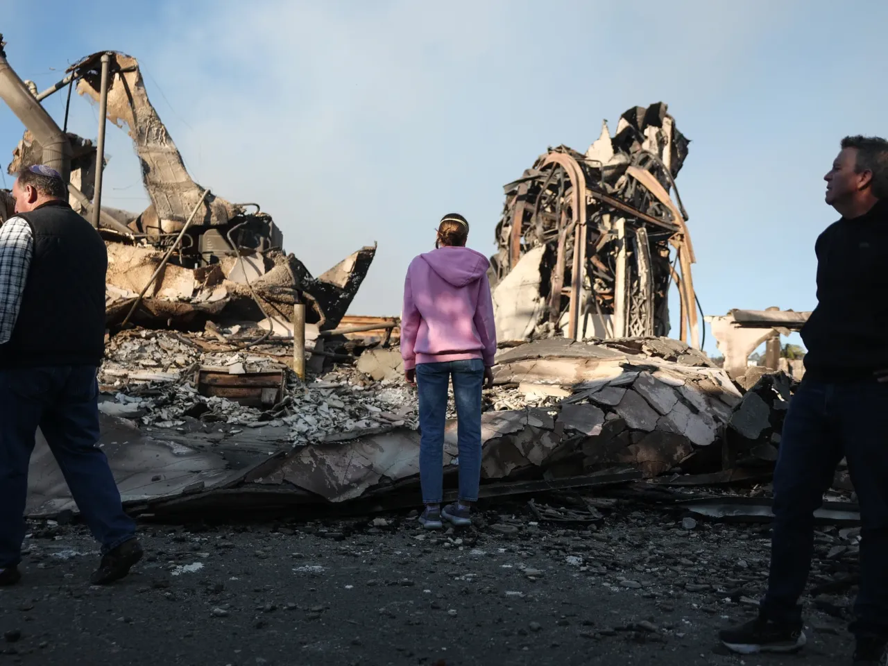 Friday, Jan. 10: Rev. John Shaver (R) looks on while visiting the remains of Community United Methodist Church, where he is pastor.