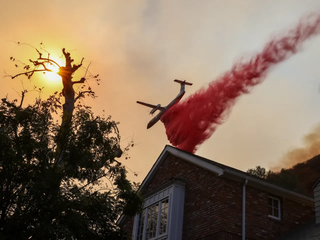 Saturday, Jan. 11: A plane drops pink fire retardant near the Brentwood neighborhood.
