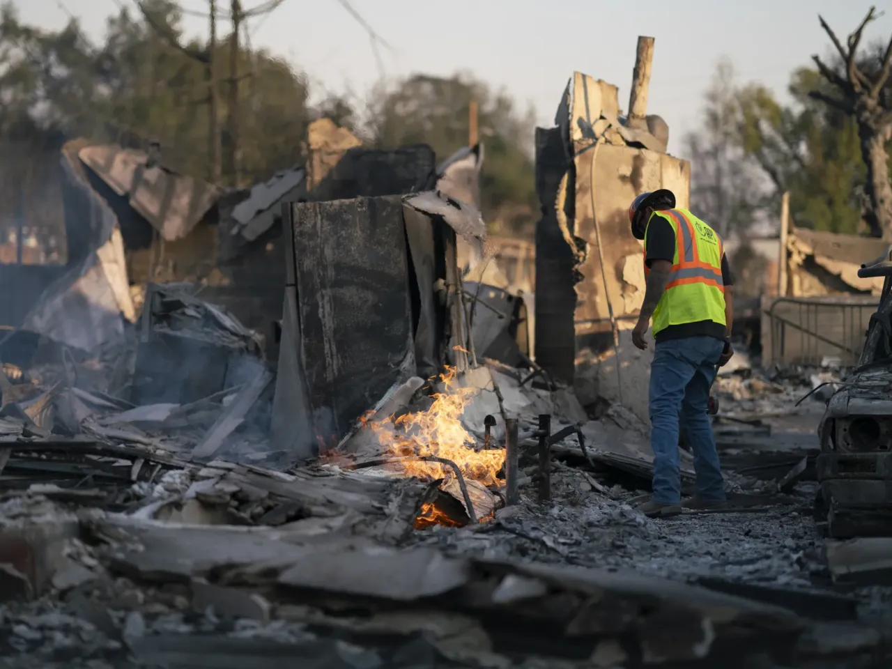 Friday, Jan. 10: Johnathon Vera with Arizona Pipeline Company works to extinguish a still burning gas line fire in Altadena.