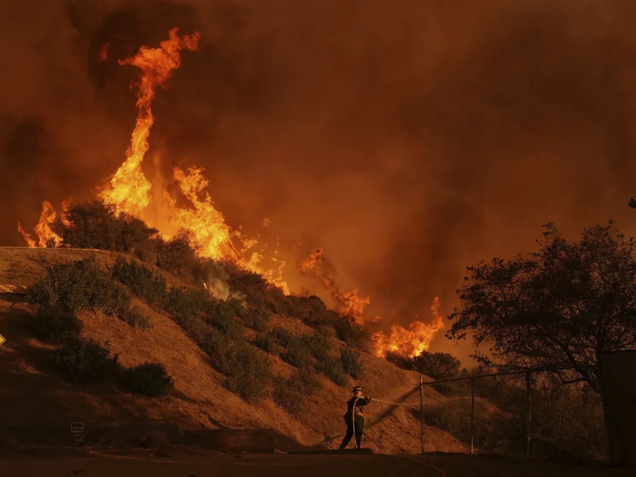 Saturday, Jan. 11: A firefighter battles the Palisades Fire in Mandeville Canyon.