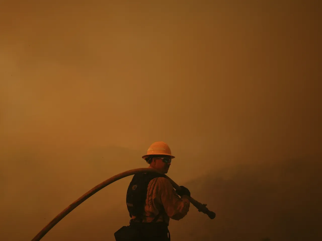 Saturday, Jan. 11: A firefighter monitors the advance of the Palisades Fire in Mandeville Canyon.