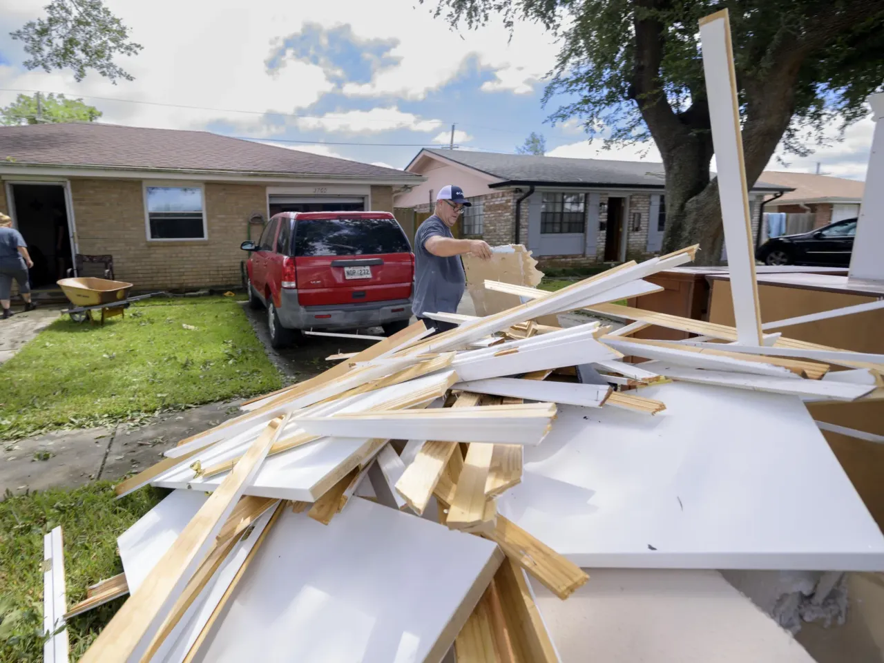 In the aftermath of Hurricane Francine on Sept. 12 in Kenner, La., Shawn Murphy removes drywall at a friend's house after floodwater came up a few inches in the house, making most of the walls, floors and doors wet.