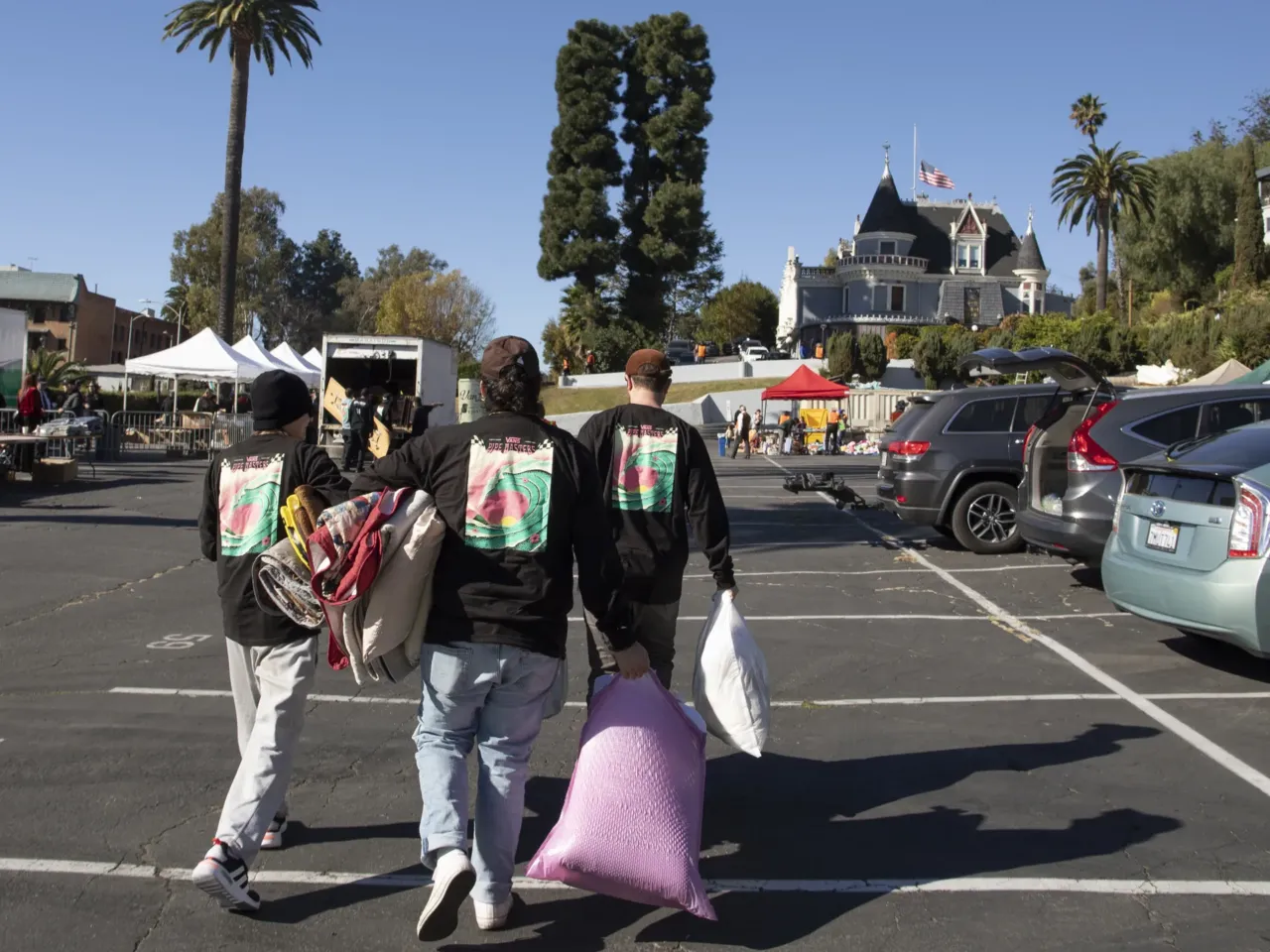 People visit the Magic Castle parking lot in Los Angeles, which has been turned into a donation pick-up and drop off center to help support tens of thousands of wildfire evacuees and victims across the county.