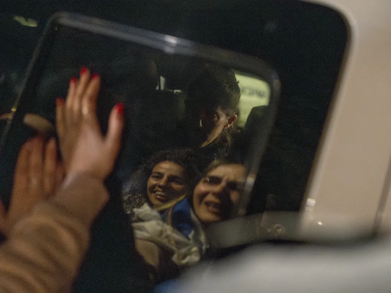 People celebrate as Freed Israeli hostages arrive in Ramat Gan after their release from Hamas captivity in the Gaza Strip on Jan. 19, 2025.