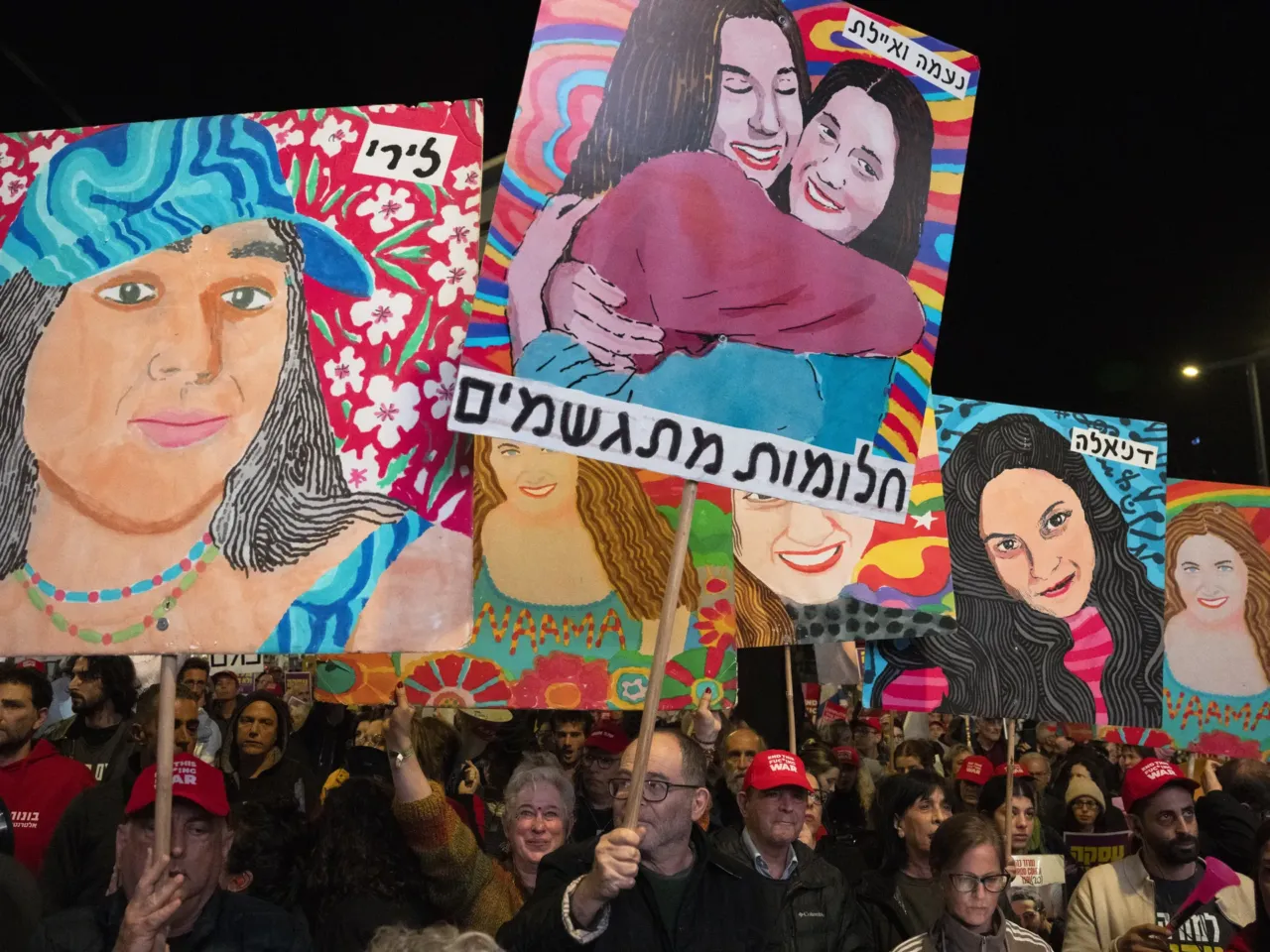 Hamas releases 4 more hostages as part of ceasefire agreement with Israel 5 Demonstrators raise placards and wave flags during a protest calling for the release of hostages in front of the Israeli Defence Ministry in Tel Aviv on Jan. 25, 2025.