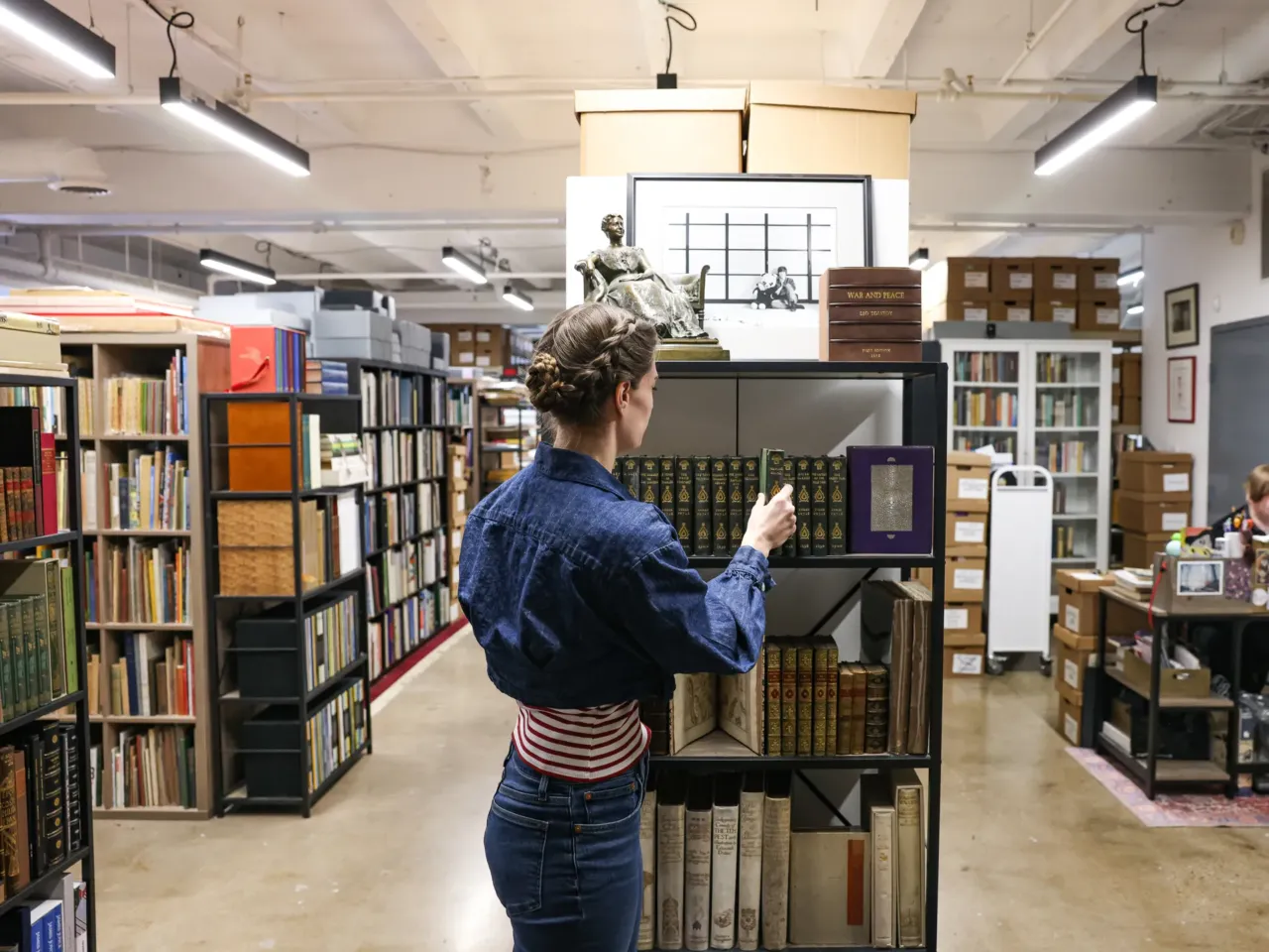Rare book dealer Rebecca Romney dedicates a book to the women Jane Austen read 3 Rare book collector Rebecca Romney arranges novels at Type Punch Matrix in Silver Spring, Md.