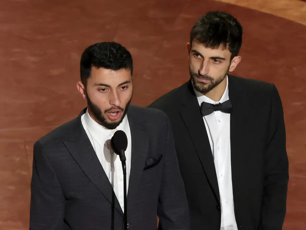 Rachel Szor, left, Hamdan Ballal, Basel Adra and Yuval Abraham accept the Oscar for best documentary feature film for No Other Land.