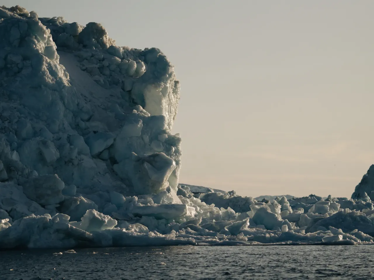 As Greenland prepares for tourism increase, a moment of stillness among the icebergs 1 The sunset reflects off of an iceberg in Ilulissat, Greenland.