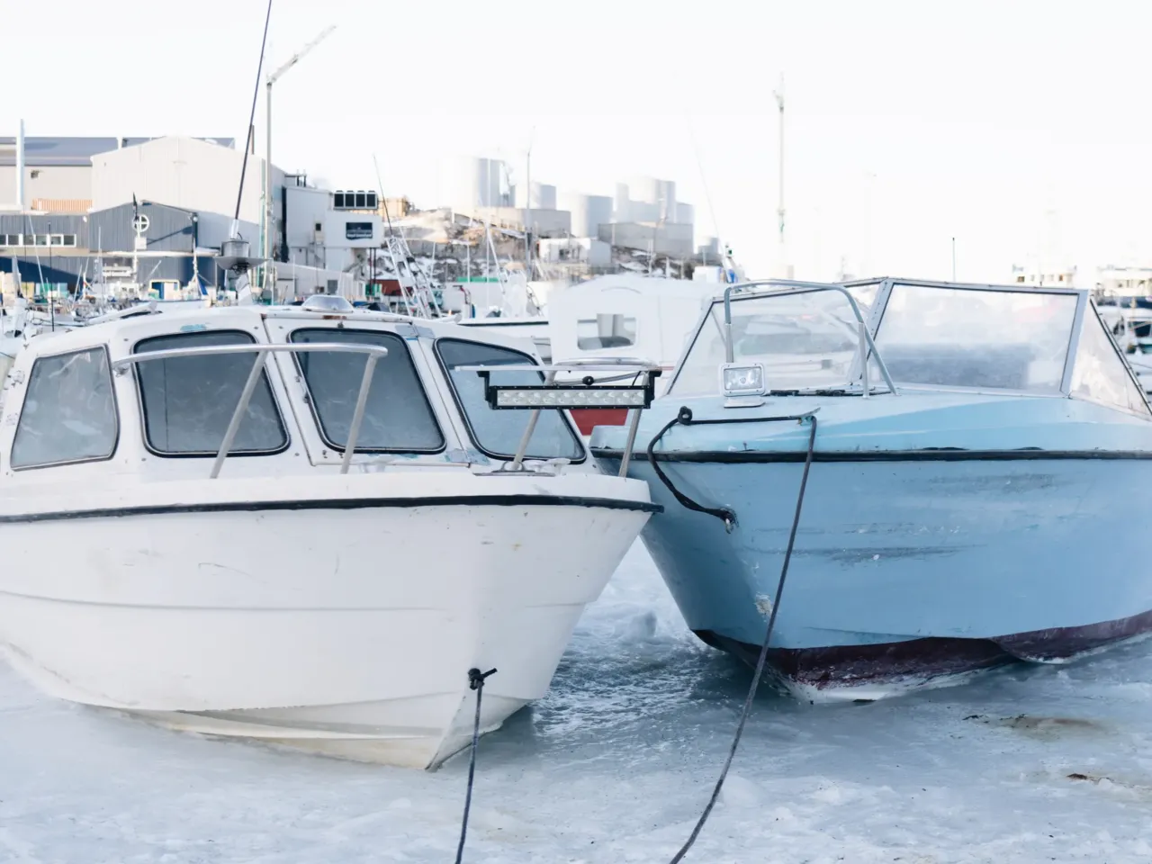 As Greenland prepares for tourism increase, a moment of stillness among the icebergs 6 Boats frozen in sea ice in Ilulissat Harbor.